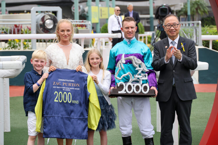 Zac Purton and his family with The Hon Martin Liao, Chairman, The Hong Kong Jockey Club, after the Australian rode a 2,000th winner in Hong Kong.